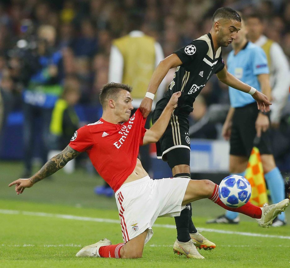 Benfica's Alex Grimaldo (left) and Ajax's Hakim Zyech vie for the ball during a Group E Champions League soccer match between Ajax and Benfica at the Johan Cruyff ArenA in Amsterdam, Netherlands on Tuesday.