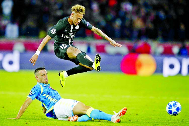 PSG's Neymar (top) is tackled by Napoli's Nikola Maksimovic during the Champions League, Group C soccer match between Paris Saint Germain and Napoli at the Parc des Princes stadium in Paris on Wednesday.