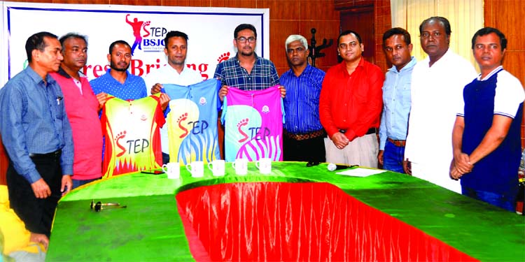 Former national cricketer Mohammad Sharif, former captain of Bangladesh National Cricket team Khaled Mashud Pilot, Managing Director of Step Footwear Md Shamim Kabir showing jerseys of the upcoming Step-BSJC Media Cup Cricket, at the conference room in th