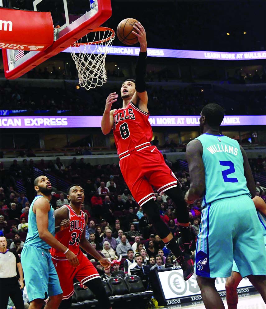Chicago Bulls guard Zach LaVine (8) goes to the basket as Charlotte Hornets forward Marvin Williams (2) stands nearby during the first half of an NBA basketball game on Wednesday.