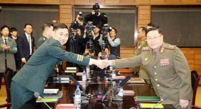 South Korean Maj. Gen. Kim Do-gyun shakes hands with his North Korean counterpart Lt. Gen. An Ik San during a meeting at the border village of Panmunjom, North Korea on Friday