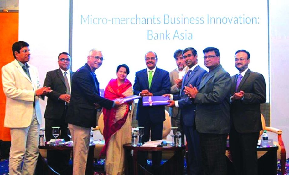 Md. Arfan Ali, President and Managing Director of the Bank Asia Limited and Rajeev Kumar Gupta, Programme Manager of SHIFT SAARC and ASEAN, UNCDF, exchanging an agreement signing document at a hotel in the city recently for launching a pilot implementatio