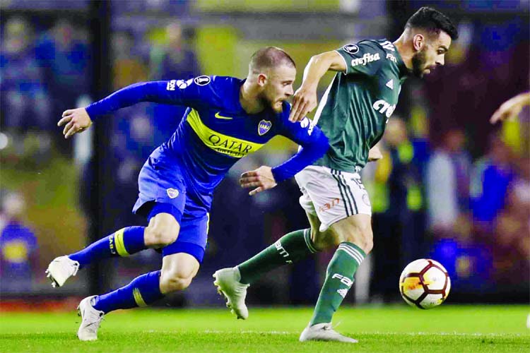 Nahitan Nandez of Argentina's Boca Juniors (left) and Bruno Henrique of Brazil's Palmeiras battle for the ball during a Copa Libertadores semifinal first leg soccer match in Buenos Aires, Argentina on Wednesday.