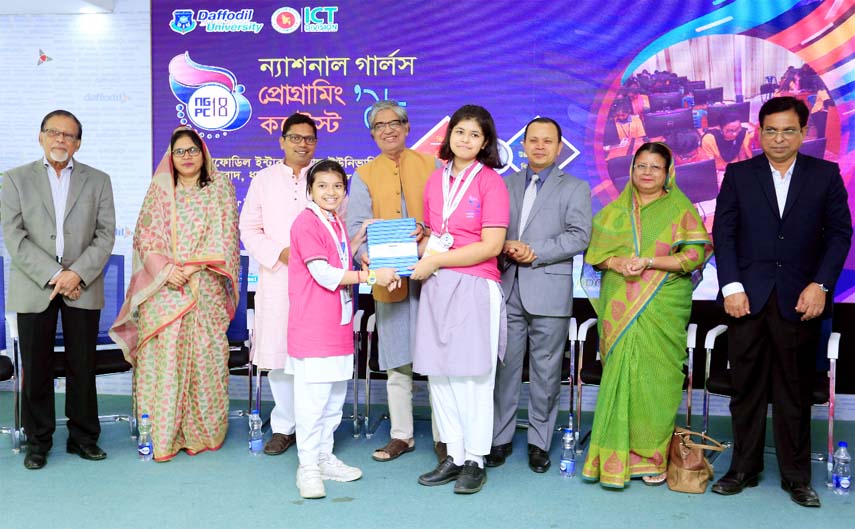 ICT Minister Mustafa Jobbar hands over the trophy of '3rdNational Girls Programming Contest-2018' to the members of winning Daffodil International School in a formal ceremony at Daffodil International University on Monday.