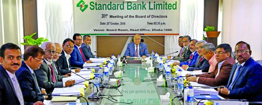 Kazi Akram Uddin Ahmed, Chairman, Board of Directors of Standard Bank Limited, presiding over its 301st meeting at the Bank's head office in the city recently. Mamun-Ur-Rashid, Managing Director, Mohammed Abdul Aziz, Vice-Chairman, Kamal Mostafa Chowdhur