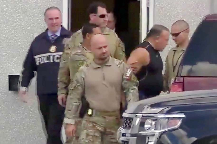 Cesar Altieri Sayoc, who was arrested during an investigation into a series of parcel bombs, is escorted from an FBI facility in Miramar, Florida on Friday.