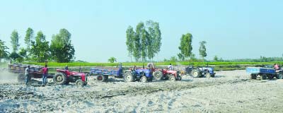 ULIPUR (Kurigram): Illegal sand lifting from Teesta River is going on at Ulipur Upazila point. This snap was taken yesterday.