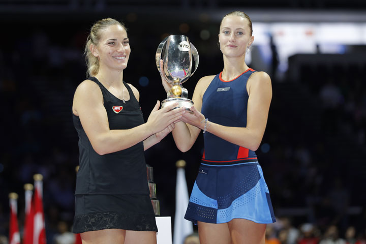 France's Kristina Mladenovic (right) and Hungary's Timea Babos celebrate with the trophy after winning the doubles final against Czech Republic's Katerina Siniakova and Czech Republic's Barbora Krejcikova women's double at the WTA tennis finals in Si