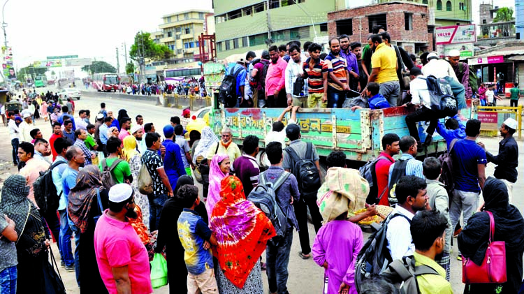 City people going to their respective destination from Gabtali on Monday boarding on a truck as no passenger bus was seen on the road due to transport workers' strike.