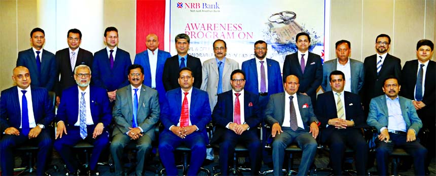 Mohammed Mahtabur Rahman, Chairman of NRB Bank Limited, poses for a photo session with the participants of a training programme on 'Anti Money Laundering and Combating the Financing of Terrorism' for its directors at the Bank's head office in the city