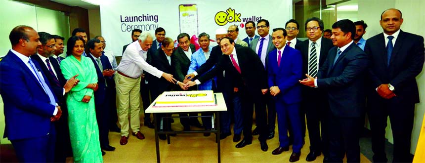 Sayeed H. Chowdhury, Chairman, Board of Directors of ONE Bank Limited, inaugurating its OK wallet service by cutting a cake at the Bank's head office in the city on Tuesday. M Fakhrul Alam, Managing Director, Ashok Das Gupta, Vice-Chairman, Zahur Ullah,
