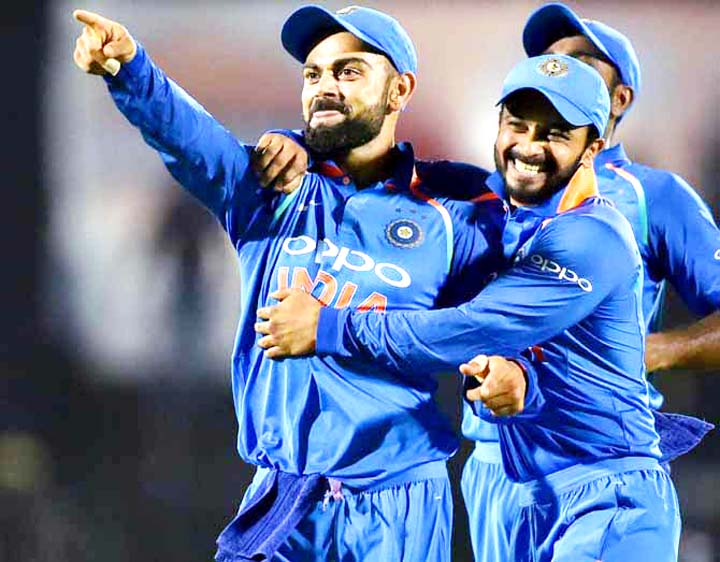 Captain Virat Kohli (left) of India celebrates the run out of Kieran Powell with his teammates in the fourth One Day International match between India and West Indies in Mumbai on Monday. India beat West Indies by 224 runs.