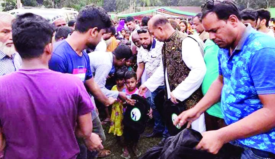 BANARIPARA (Barishal): Capt (Retd) M Mouazzam Hosssain Bubly , aspirant MP candidate from Awami League in Braishal -2 constituency distributing school bags among the children in Banaripara Upazila recently.