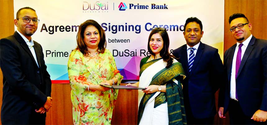 Shaila Abedin, Head of Segments of Prime Bank Limited and Regina Nasser, Director of DuSai Resort & Spa, exchanging an agreement signing documents at the Bank's head office in the city recently. Under the deal, Monarch (Priority Banking) customers, credi