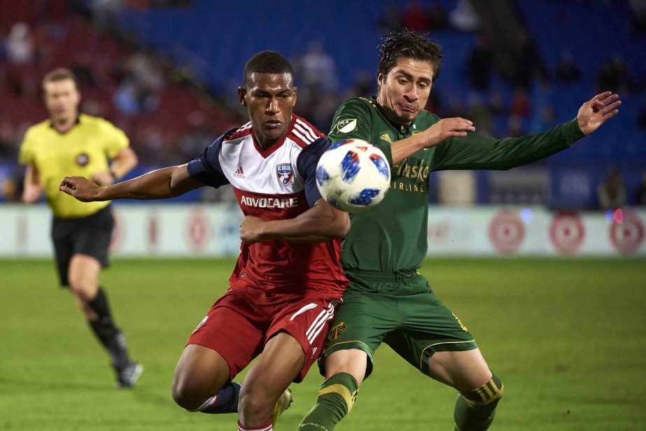 FC Dallas midfielder Carlos Gruezo (front left) battles for the ball against Portland Timbers defender Jorge Villafana during the second half of an MLS soccer playoff match in Frisco, Texas on Wednesday.