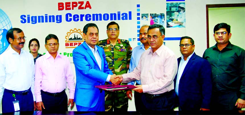 Mohammad Faruque Alam, Member of Bangladesh Export Processing Zones Authority (BEPZA) and Md. Siddiqur Rahman, Chairman of Ms. Sterling Classicwears Limited, exchanging an agreement signing document at BEPZA Complex in the city on Thursday. Under the dea