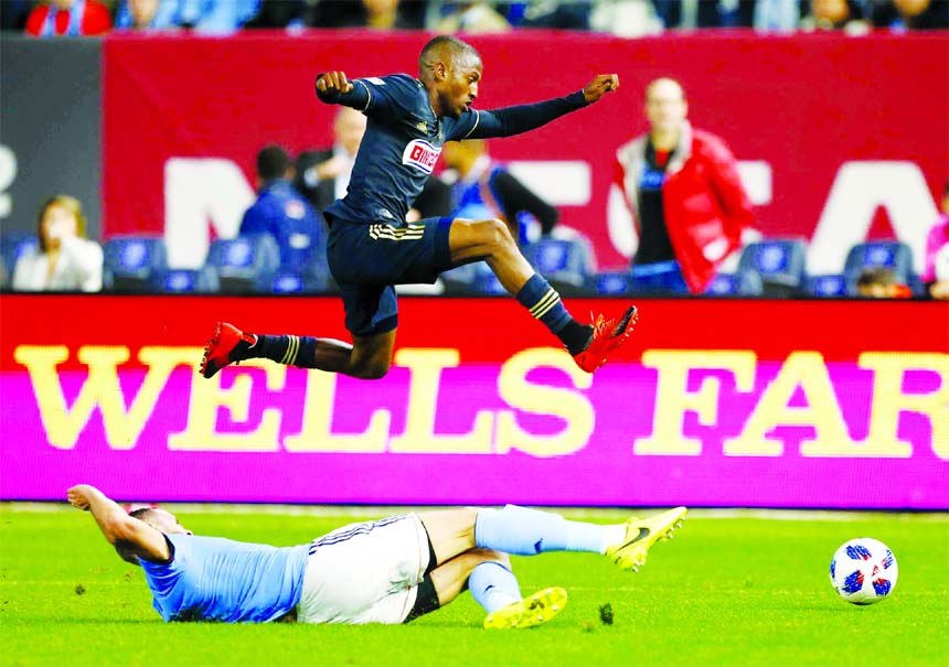 New York City FC defender Maxime Chanot (bottom) plays the ball against Philadelphia Union forward Fafa Picault during the first half of an MLS playoff soccer match in New York on Wednesday.