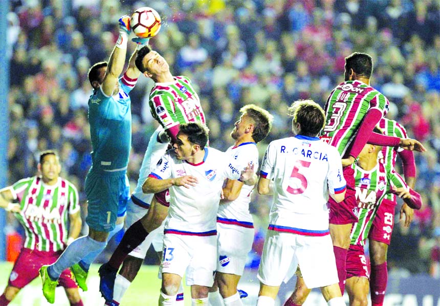 Goalkeeper Esteban Conde (second from left) of Uruguay's Nacional stops the ball during a Copa Sudamericana soccer game against Brazil's Fluminense in Montevideo, Uruguay on Wednesday.
