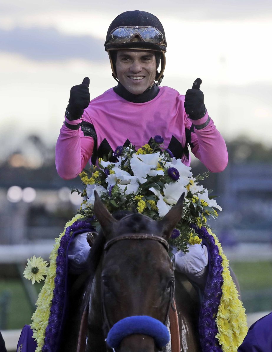 Joel Rosario celebrates after riding Game Winner to victory in the Breeders' Cup Juvenile horse race at Churchill Downs in Louisville, Ky on Friday