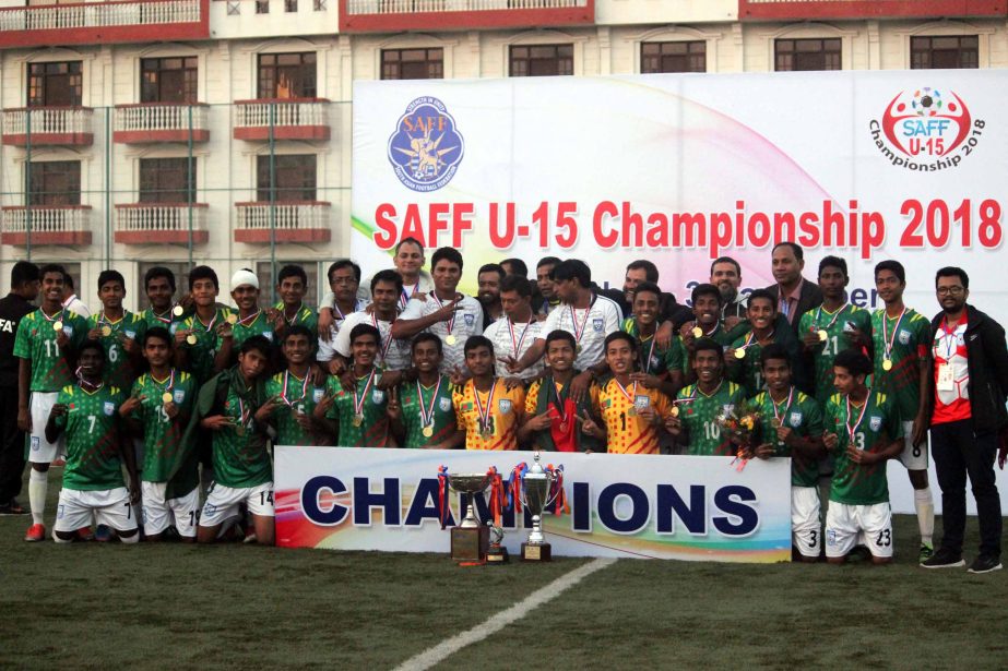 Members of Bangladesh Under-15 Football team pose with the trophy of SAFF Under-15 Championship after beating Pakistan Under-15 Football team in the final at Kathmandu, the capital city of Nepal on Saturday.