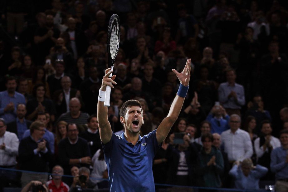 Novak Djokovic of Serbia, celebrates after defeating Roger Federer of Switzerland, during their semifinal match of the Paris Masters tennis tournament at the Bercy Arena in Paris, France on Saturday.