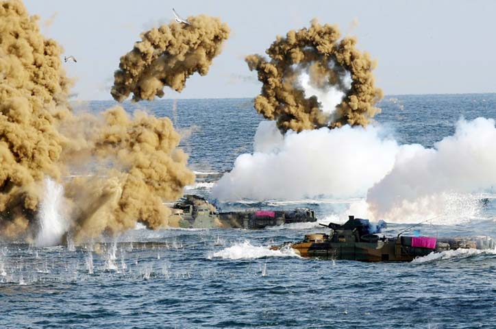 South Korean Marine amphibious assault vehicles fire smoke shells during a landing operation in the southern city of Pohang.