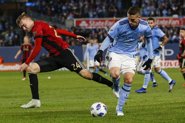 New York City FC's Ben Sweat (right) fights for the ball against Atlanta United FC's Julian Gressel during an Eastern Conference MLS soccer semifinal matchup in New York on Sunday.