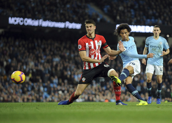 Manchester City's Leroy Sane (second left) scores his side's sixth goal during the English Premier League soccer match between Manchester City and Southampton at Etihad stadium in Manchester, England on Sunday.