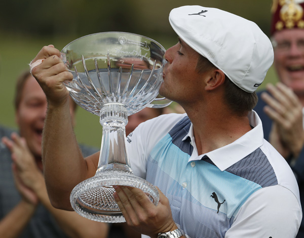Bryson DeChambeau kisses the trophy after winning the Shriners Hospitals for Children Open golf tournament in Las Vegas on Sunday.