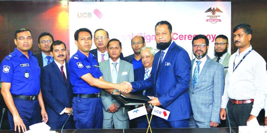 N Mustafa Tarek, DMD of United Commercial Bank Limited (UCB) and Ferdoush Ali Chowdhury, Assistant Inspector General of Police, exchanging an agreement signing documents at the Bank's head office in the city recently. Under the deal, the bank will take s