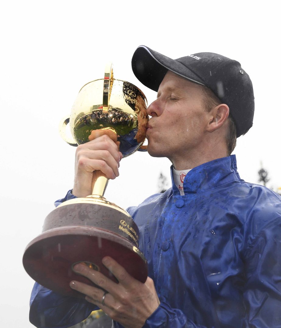Jockey of Cross Counter, Kerrin McEvoy kisses his cup after winning the Melbourne Cup at the Flemington Racecourse in Melbourne, Australia on Tuesday.