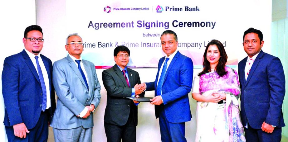 ANM Mahfuz, Head of Consumer Banking of Prime Bank and Sujit Kumar Bhowmik, AMD of Prime Insurance Company Limited, exchanging an agreement signing documents at the Bank's head office in the city recently. Under the deal, Monarch Customers of the Bank wi