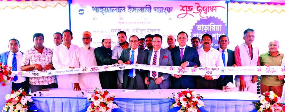 M. Shahidul Islam, Managing Director of Shahjalal Islami Bank Limited, inaugurating its 116th Branch at Vararia Bazar in Manikganj on Monday. Abdul Aziz, Imtiaz U Ahmed, DMDs, Md. Mahbubur Rasheed, Head of Common Services Division, Md. Shamsuddoha, Head o