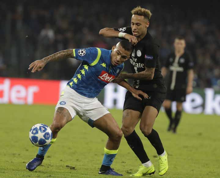 Napoli's Marques Allan (left) and PSG's Neymar vie for the ball during a Champions League, group C soccer match between Napoli and Paris Saint Germain, at the San Paolo stadium in Naples, Italy on Tuesday.