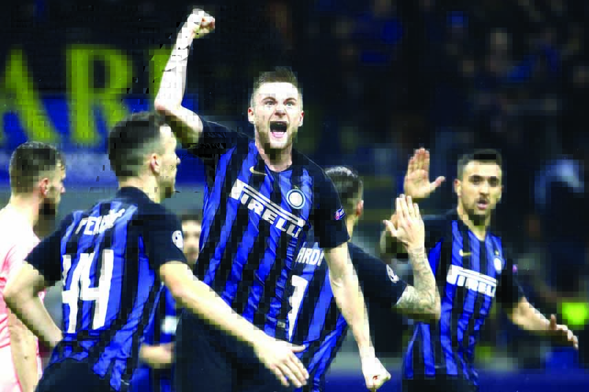Inter defender Milan Skriniar (center) celebrates after his teammate Inter forward Mauro Icardi, scored his side's opening goal during the Champions League group B soccer match between Inter Milan and Barcelona at the San Siro stadium in Milan, Italy on