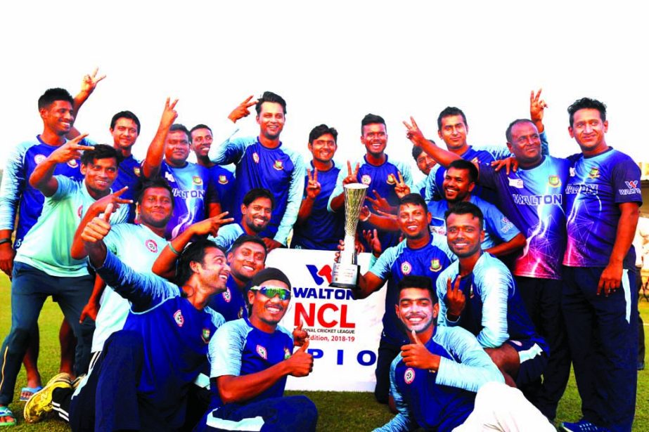 Players of Rajshani Division team, the champions of the Walton National Cricket League (NCL) pose with the championship trophy at the Shaheed Kamruzzaman Stadium in Rajshahi on Thursday.