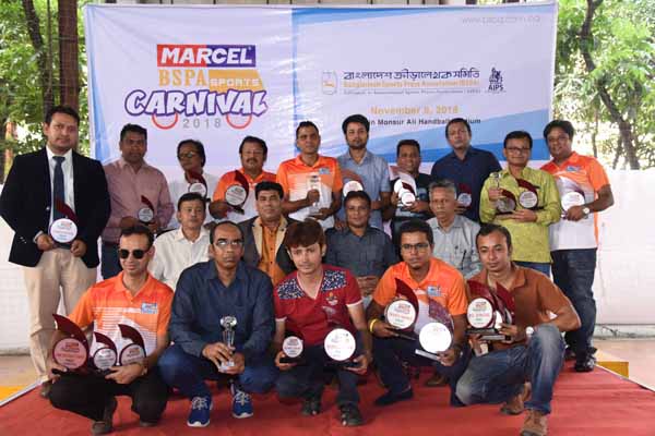 The winners of the Marcel-BSPA Sports Carnival with the guests and officials of Bangladesh Sports Press Association pose for photograph at the Shaheed Captain M Mansur Ali National Handball Stadium on Thursday.