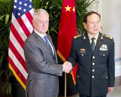 U.S Defense Secretary Jim Mattis, (left), meets Chinese Defense Minister Wei Fenghe in Singapore. Mattis and Secretary of State Mike Pompeo will meet Friday.