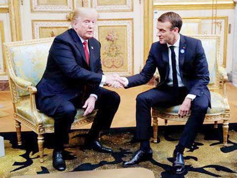 U.S. President Donald Trump shakes hands with French President Emmanuel Macron as they meet at Elysee presidential palace, as part of the commemoration ceremony for Armistice Day, 100 years after the end of the First World War, in Paris on Saturday.