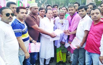 SAVAR: Monjur Alam Rajib, Joint General Secretaray, Savar Upazila Awami League distributing leaflets among the people on different development activities of present government at Saver recently.