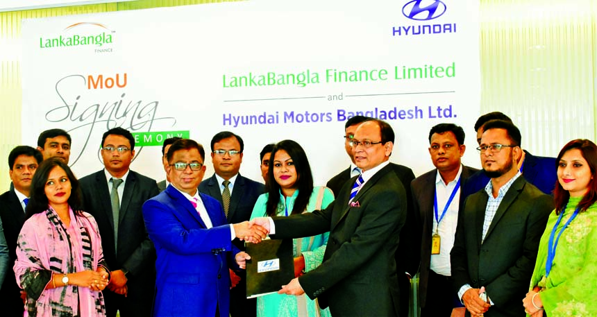 Khurshed Alam, Head of Retail Finance of LankaBangla Finance Ltd (LBFL) and Syed Shakeel Ahmed, Managing Director of Hyundai Motors Bangladesh Limited, exchanging a MoU signing document at LBFL head office in the city recently. Under the deal, employees a