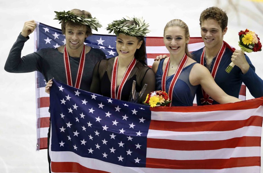 From left : Gold medalist Kaitlin Hawayek and Jean Luc Baker of the United States and bronze medalist Rachel Parsons and Michael Parsons of the United States pose for photo during an awarding ceremony at the NHK Trophy figure skating ice dance event in Hi