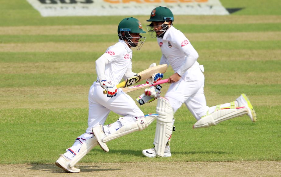 Mominul Haque (left) and Mushfiqur Rahim running between wicket during the first day play of the second Test between Bangladesh and Zimbabwe at the Sher-e-Bangla National Cricket Stadium in the city's Mirpur on Sunday. Both batsmen hit century each on th