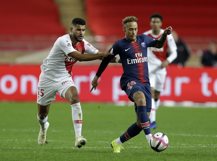 Monaco's Youssef Ait-Bennasser (left) battles for the ball with PSG's Neymar during the French League One soccer match between AS Monaco and Paris Saint-Germain at Stade Louis II in Monaco on Sunday.