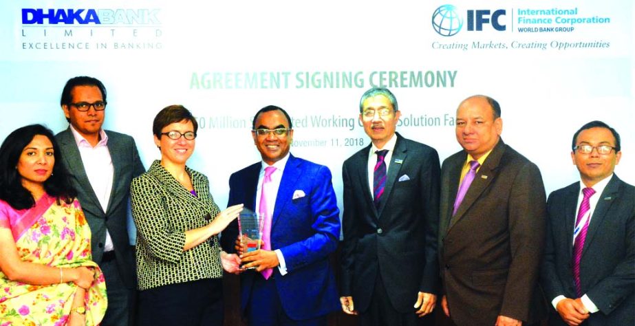 Syed Mahbubur Rahman, Managing Director of Dhaka Bank Limited, receiving a crest from Wendy Werner, Country Manager for Bangladesh, Bhutan and Nepal of International Finance Corporation (IFC) after signed the Working Capital Solutions facility agreement o