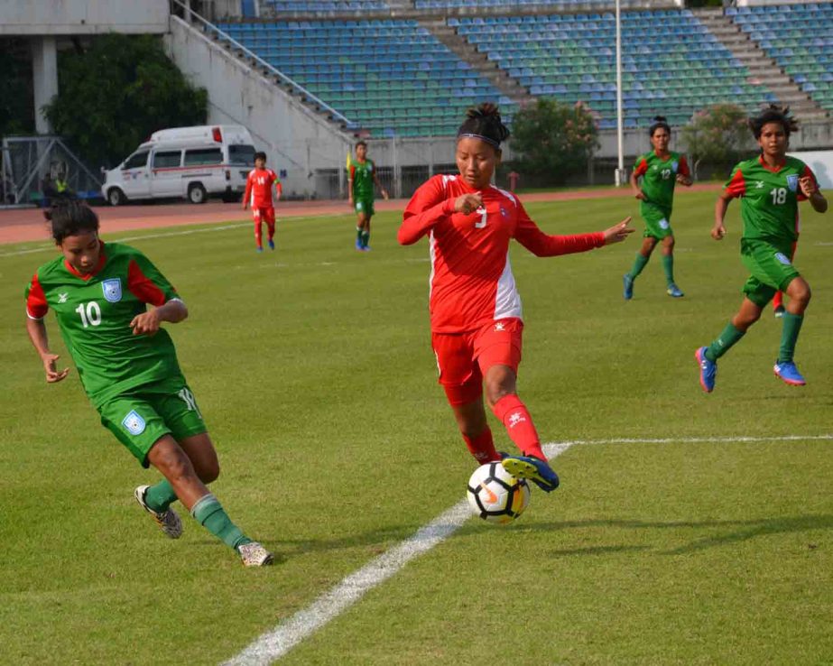 A moment of the football match of the Asian Qualifiers of the Women's Olympic Football Tournament between Bangladesh Olympic Women's Football team and Nepal Women's Olympic Football team at Yangon in Myanmar on Tuesday. The match ended in a 1-1 draw.