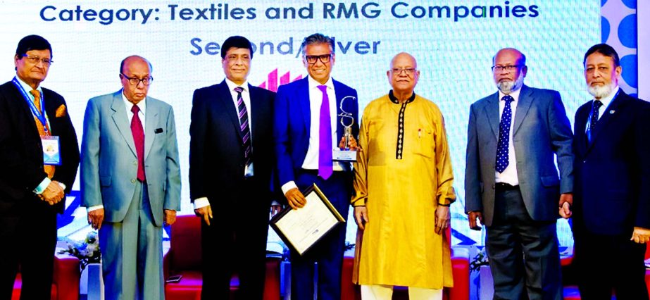 Sakhawat Hossain, Managing Director of Paramount Textile Limited, poses for a photograph after receving the 5th ICSB National Award-2017 in Textile and RMG category for Corporate Governance Excellence from Finance Minister Abul Maal A Muhith, at a hotel i