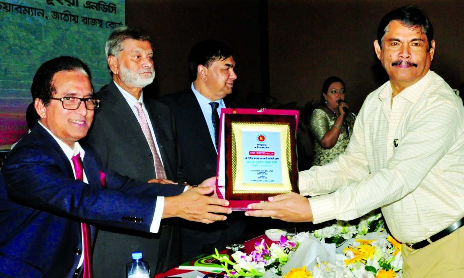 Babu Subod Ranjon Das, receiving the Highest Taxpayer Awarded of Norshingdi District in 2017-2018 tax year from State Minister for Finance and Planning Ministry MA Mannan MP at Pan Pacific Sonargaon Hotel on Monday. Md. Mosharraf Hossain Bhuiyan, NBR Chai