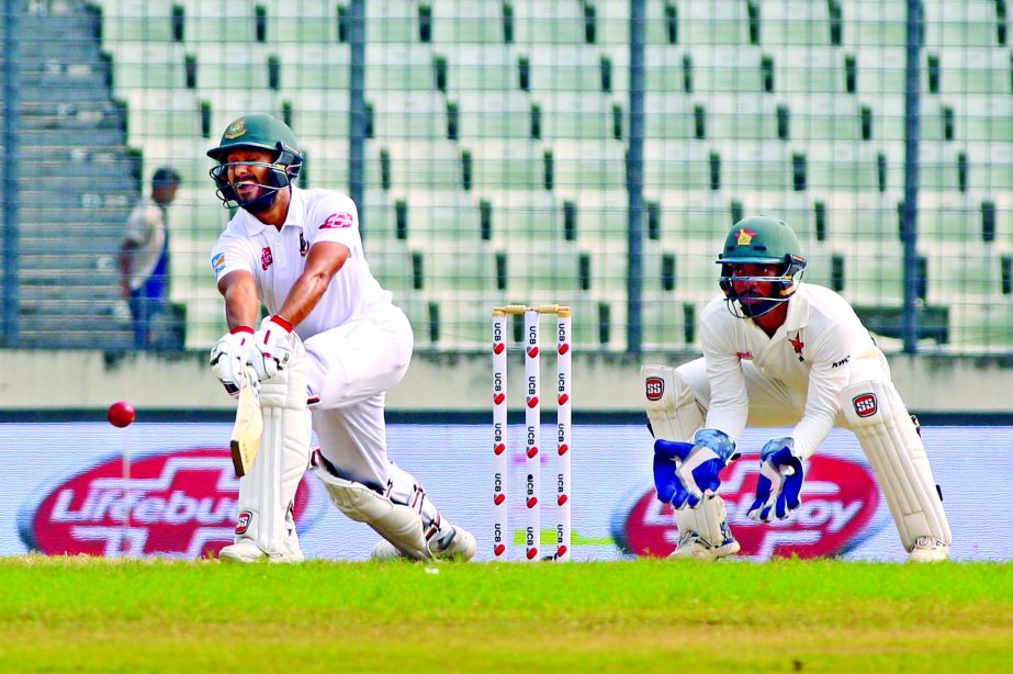 Mohammad Mithun (left) of Bangladesh plays a shot while wicketkeeper Regis Chakabva of Zimbabwe looks on during the fourth day play of the second Test between Bangladesh and Zimbabwe at the Sher-e-Bangla National Cricket Stadium in the city's Mirpur on W