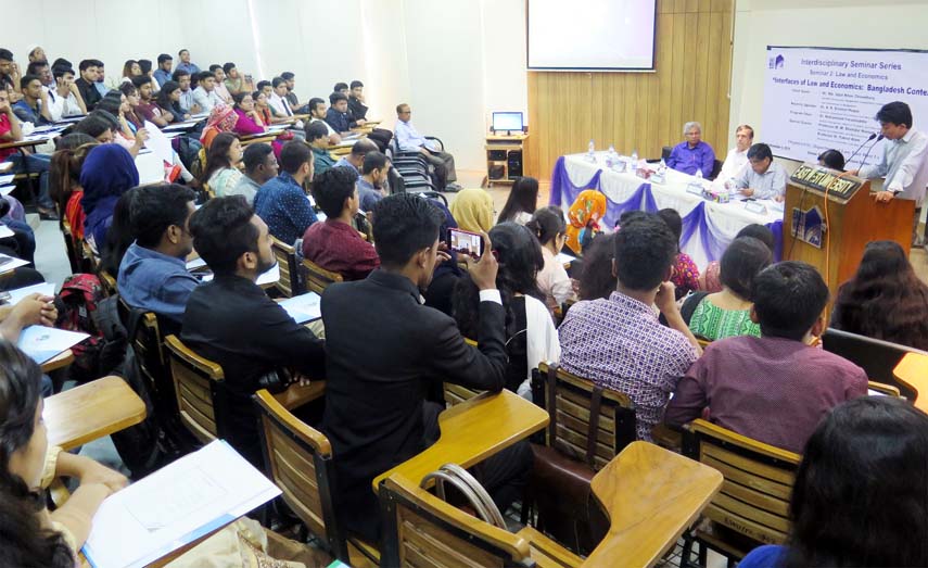 Dr AK Enamul Haque, Professor, Department of Economics of East West University speaks as keynote speaker at a seminar at the University recently.